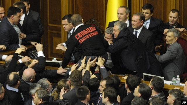 Lawmakers fight in Ukraine's parliament in Kyiv, Ukraine, December 12, 2012. 