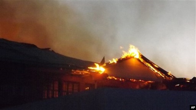 The Garissa Halgan Quran House Resort Hotel is engulfed in flames after Kenyan security personnel, according to residents, swept into the predominantly ethnic-Somali town beating people and burning property, northern Kenya, Nov. 19, 2012.