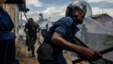 FILE - Burundi's policemen and army forces run after protesters against incumbent president Pierre Nkurunziza's bid for a 3rd term on May 13, 2015 in Bujumbura, May 13, 2015. Officials in Burundi say at least five people were killed and six injured when gunmen opened fire on a market Monday evening.