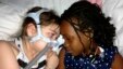 Sarah Murnaghan, left, lies in her hospital bed next to adopted sister Ella on the 100th day of her stay in Children's Hospital of Philadelphia, (File photo).