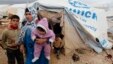 Syrian refugees leave their tents after heavy rain, Al-Zaatari refugee camp, Mafraq, Jordan, Jan. 8, 2013.