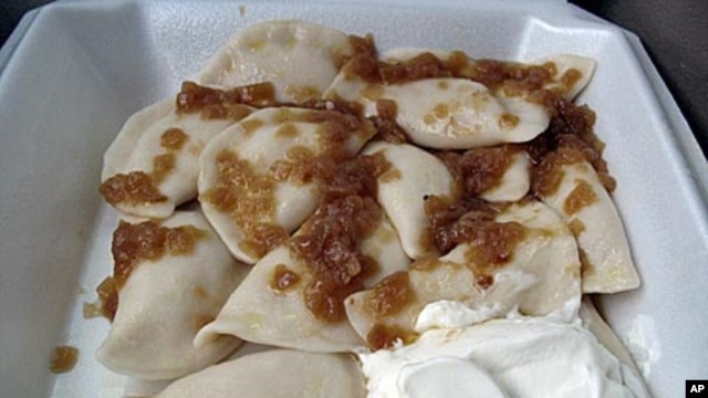 A to-go serving from St. John's Baptist Ukrainian Church includes a dozen pierogies tossed in melted butter, topped with caramelized onions and served with a generous dollop of sour cream.