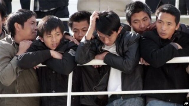 Chinese citizens wait aboard the 'Palermo Grimaldi' ferry at the harbor in Valletta, Malta, after being evacuated from Benghazi, Libya, Feb. 26, 2011.