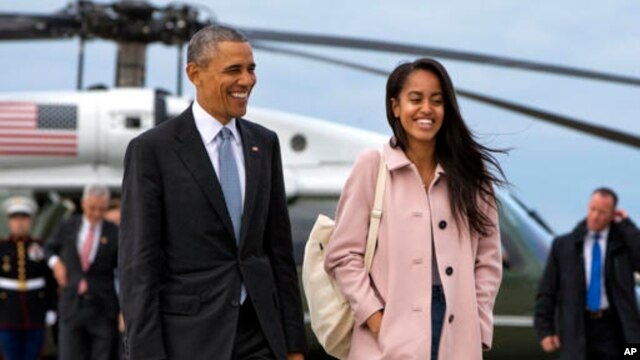 FILE - President Barack Obama jokes with his daughter Malia Obama as they walk to board Air Force One from the Marine One helicopter, April 7, 2016.