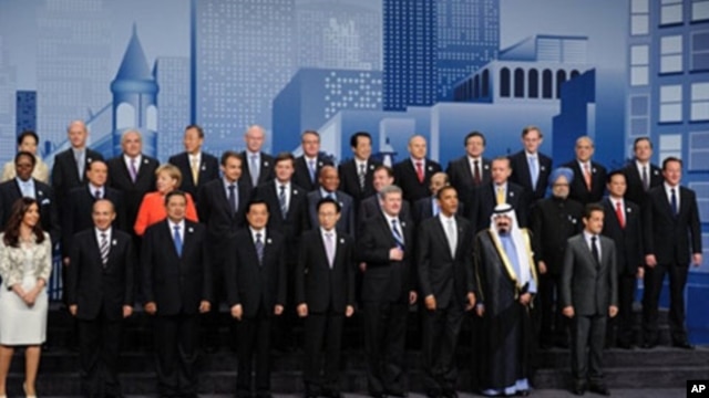 Heads of states and governments and other dignitaries pose for a family picture during the G20 summit at the convention center in Toronto,  27 Jun 2010.