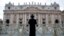 A priest stands in front of Saint Peter's Basilica as a red curtain has been put on the central balcony, called the Loggia of the Blessings, at the Vatican, March 11, 2013.