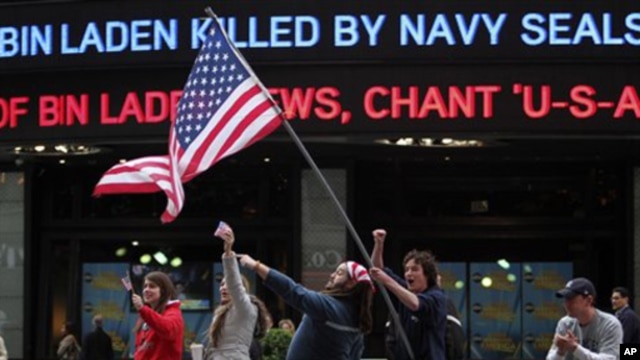People celebrate outside the ABC studios in New York's Times Square as news of Osama bin Laden's death is announced on the ticker,  Monday, May 2, 2011