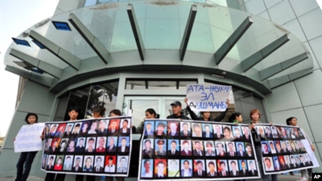 People hold posters with pictures of their killed relatives during a rally near the office of former Kyrgyz president Kurmanbek Bakiyev's Ata-Zhurt party in Bishkek on 6, Oct. 2010.  Parliamentary elections are set for Sunday, the tenth.