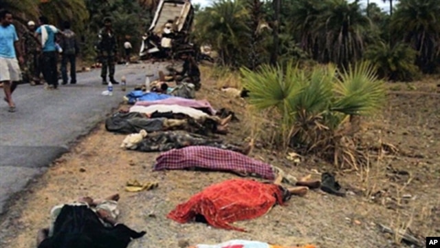 Bodies seen by roadside near the mangled wreckage of a bus which hit a landmine planted by maoist rebels in Dantewada district of Chhattisgarh, India, 17 May 2010