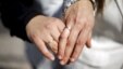 A same-sex couple displays rings in honor of their civil union, legal for the first time in Santiago, Chile, Oct. 22, 2015.