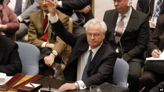 Russian representative Vitaly Churkin vetoes a draft resolution backing an Arab League call for Syrian President Bashar Assad to step down during a meeting of the United Nations Security Council at United Nations headquarters on Saturday, Feb. 4, 2012.