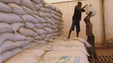 Men transport food aid intended for recently liberated portions of the country, near Sevare, Mali, Feb. 4, 2013.