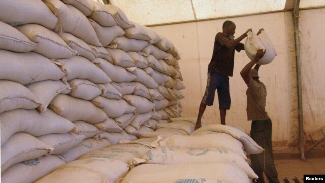 Men transport food aid intended for recently liberated portions of the country, near Sevare, Mali, Feb. 4, 2013.