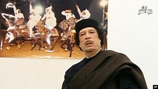 Muammar Gaddafi speaks at a Tripoli hotel in this still image from Libyan TV, released May 11, 2011