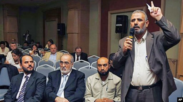 Jamal Al Wadi from the Syrian city of Daraa speaks as Syrian opposition members listen after they announced a Syrian National Council in their bid to present a united front against President Bashar al-Assad's regime, in Istanbul, Turkey, September 15, 201