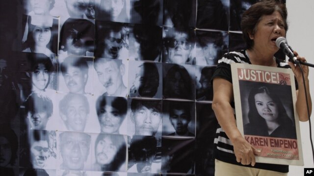 Mother of missing student activist Karen, speaks in front of a photo mosaic of Philippine President Benigno Aquino III during a rally to commemorate International Day of the Disappeared in Manila, Philippines, August 30, 2012.