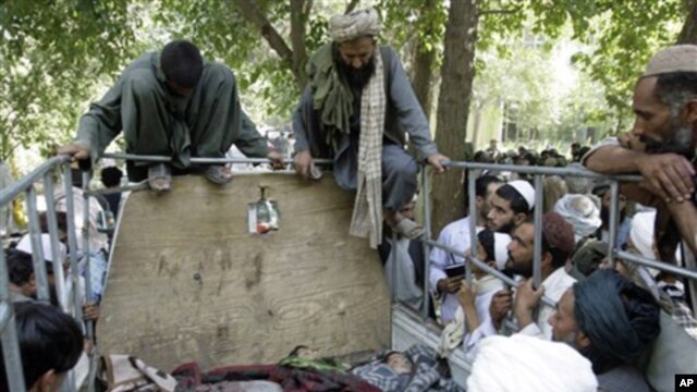 Afghan villagers look at the bodies of two children and a villager after they were allegedly killed in an airstrike by foreign troops in Kandahar, south of Kabul (file)