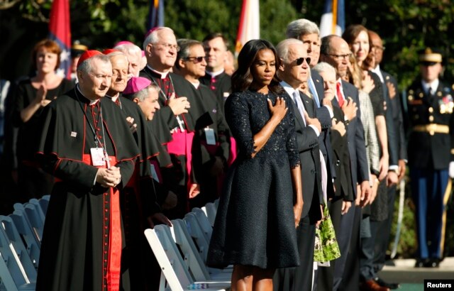 U.S. first lady Michelle Obama stands with U.S. bishops and members of the President Barack Obama's cabinet during an arrival ceremony for Pope Francis at the White House in Washington, Sept. 23, 2015.