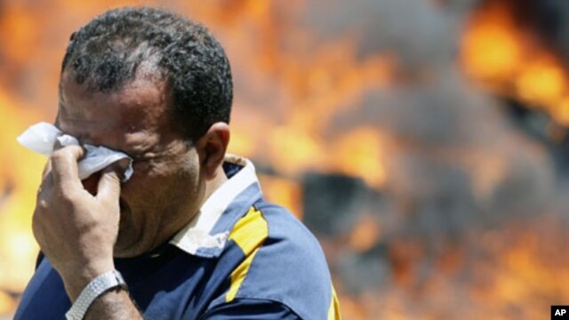 A protester wipes his eyes after being affected by tear gas in front of the Interior Ministry in Cairo