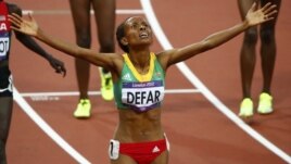 Ethiopia's Meseret Defar celebrates after winning the women's 5,000-meter final during the London 2012 Olympic Games at the Olympic Stadium, August 10, 2012.