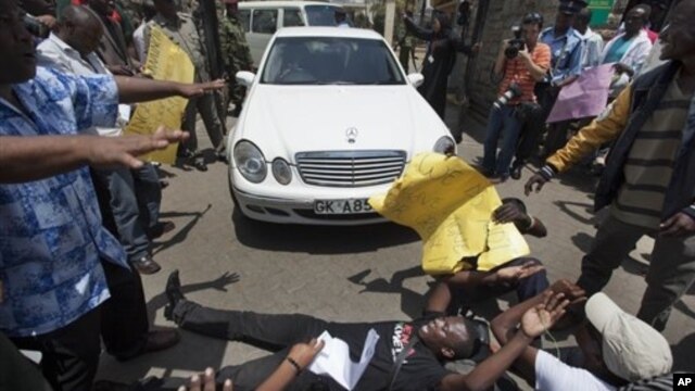 Protester lays down outside Kenyan Parliament to block legislators from leaving, Nairobi, Oct. 9, 2012.