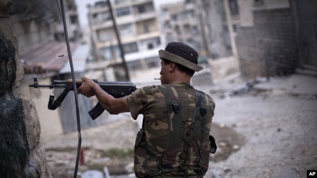 A Free Syrian Army fighter fires his weapon at Syrian Army positions in Aleppo, Syria. Piece by piece, Syria's rebels are slowly starting to expand their arsenal and get their hands on more advanced weapons, September 11, 2012