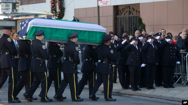The casket of New York Police Department Officer Rafael Ramos arrives at his wake at Christ Tabernacle Church in the Glendale section of Queens, New York, where he was a member, Dec. 26, 2014.