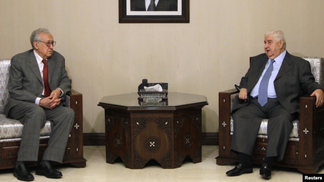 Syria's Foreign Minister Walid al-Moualem (R) meets with U.N-Arab League peace envoy for Syria Lakhdar Brahimi in Damascus, October 20, 2012. 