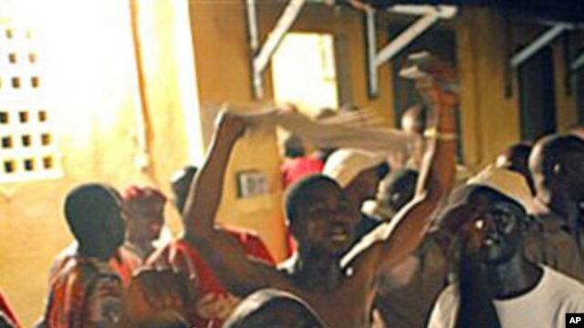 Supporters of Guinean presidential candidate Alpha Conde celebrate at his headquarters after it was announced by the National Independent Electoral Commission that the preliminary results showed he had won Guinea's tense presidential election, 15 Nov 2010