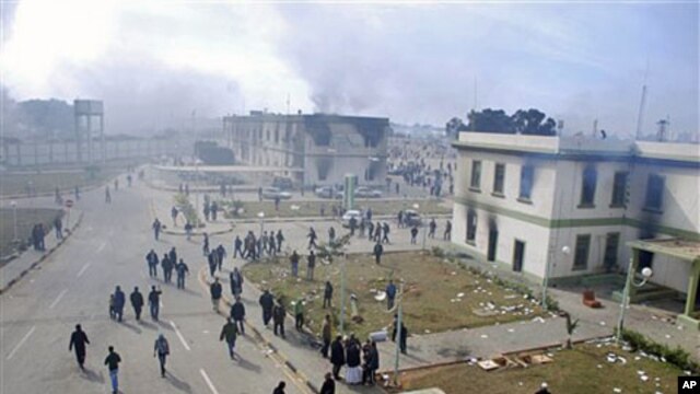 Buildings at the entrance to a security forces compound are seen burning in Benghazi on Feb 21 2011