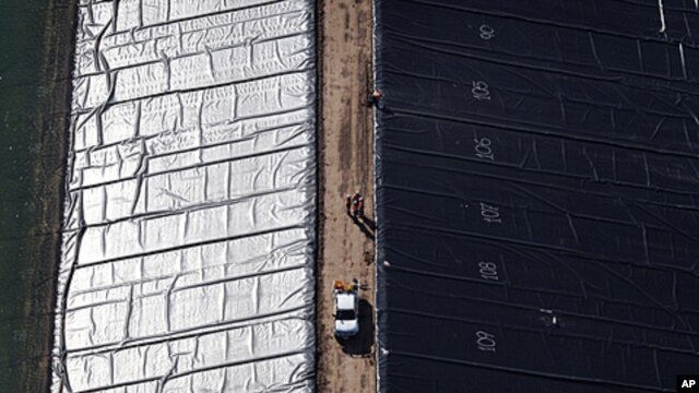 A facility for holding water pumped from underground during coal-seam gas mining is lined with black plastic before use on a property near Cecil Plains, 180 km (112 miles) west of Brisbane, October 31, 2011.