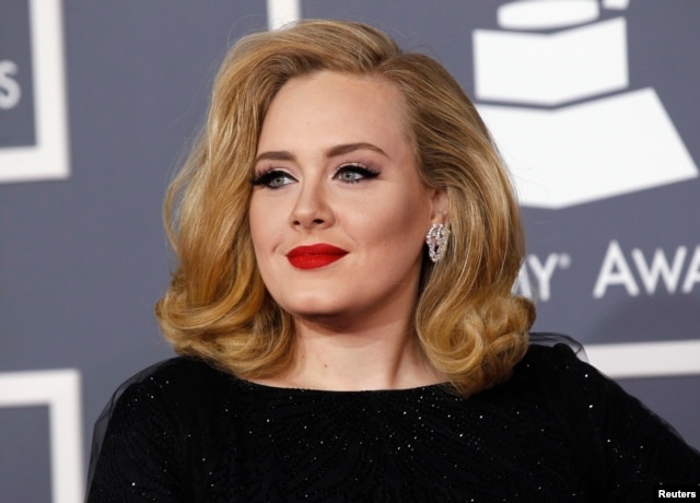 FILE - British singer Adele arrives at the 54th annual Grammy Awards in Los Angeles, California, Feb. 12, 2012.