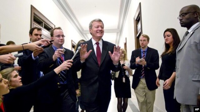 Senate Finance Committee Chairman Sen. Max Baucus, fends off reporters as he arrives to meet in the Capitol Hill office of Sen. John Kerry, and other Supercommittee members in Washington, Nov. 21, 2011