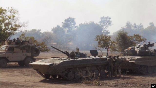 FILE - In this photo made available by the Nigerian Military taken Tuesday, April 28, 2015, Nigerian military personnel in action during an attack on Islamic extremists in the Sambisa Forest, Nigeria. 