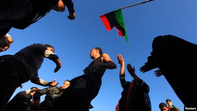 People dance as they mark the second anniversary of the country's revolution in Benghazi, Feb. 16, 2013.