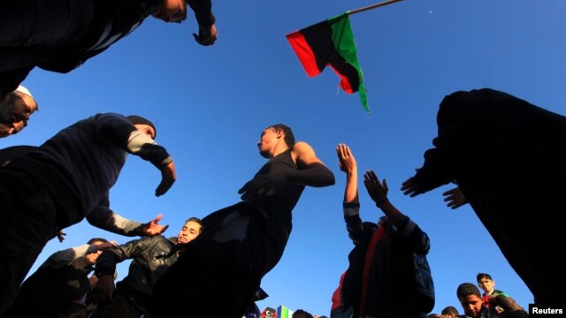 People dance as they mark the second anniversary of the country's revolution in Benghazi, Feb. 16, 2013.