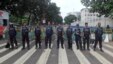 Bangladeshi police officials stand guard on a street during a general strike in Dhaka, Bangladesh, Oct. 27, 2013.