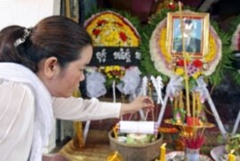 Sam Chanthy, wife of Chut Wutty, lights incense during Wutty's funeral at his house in Kandal province, Cambodia, April 28, 2012.