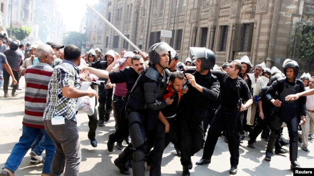 Polisi wanamkamata mfuasi wa rais aliyepinduliwa Misri Mohamed Mursi wakati wa mapambano katikati ya Cairo Ogusati 13, 2013.