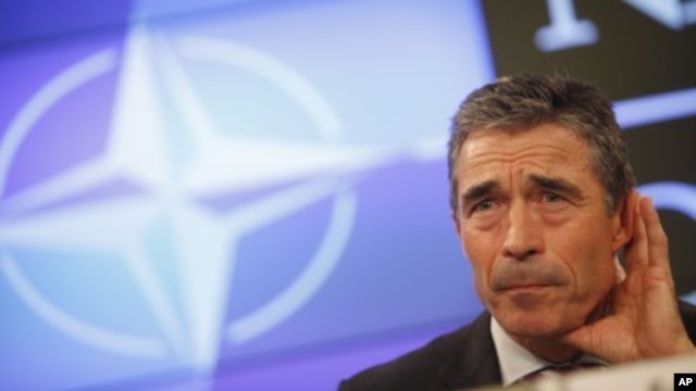 NATO Secretary-General Anders Fogh Rasmussen listens to a question during a media conference at the Residence Palace in Brussels, July 6, 2011