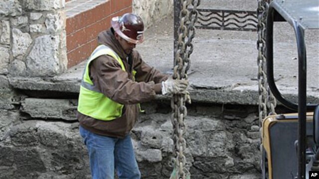 A worker does his job along the San Antonio River Walk in San Antonio, Texas, after the river was drained to clean out silt and make repairs, Jan. 7, 2011