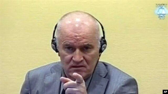 Wartime Bosnian Serb army chief Ratko Mladic gestures at his long-awaited first appearance before a U.N. judge in The Hague, June 3, 2011