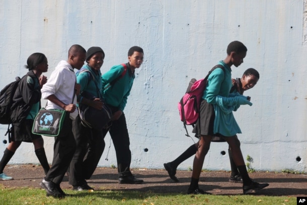 FILE - Students leave school at the end of the day in a suburb of Johannesburg, South Africa.