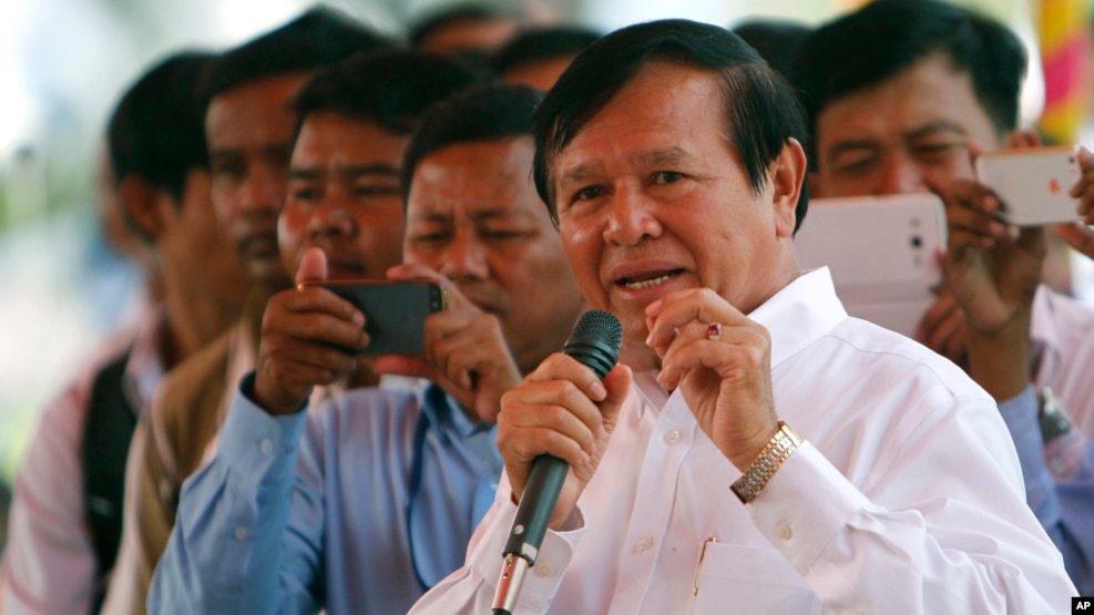 Cambodian Vice President of the National Assembly Kem Sokha, also vice president of Cambodia National Rescue Party, foreground, delivers a speech during a Buddhist ceremony to mark 18th anniversary in Phnom Penh, Cambodia, Monday, March 30, 2015.