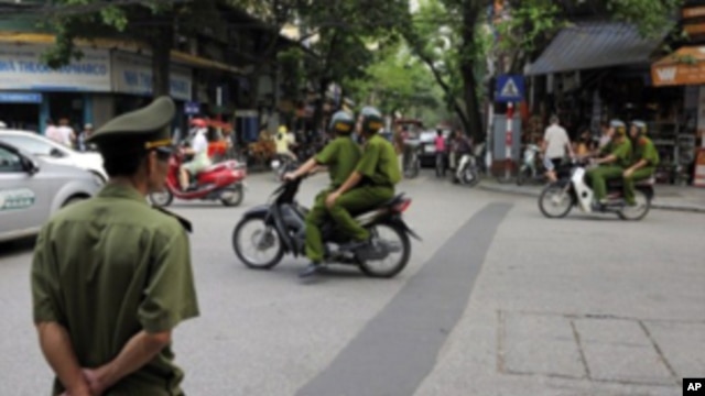 Policemen on motorcycle in Hanoi, Vietnam, June 11, 2010