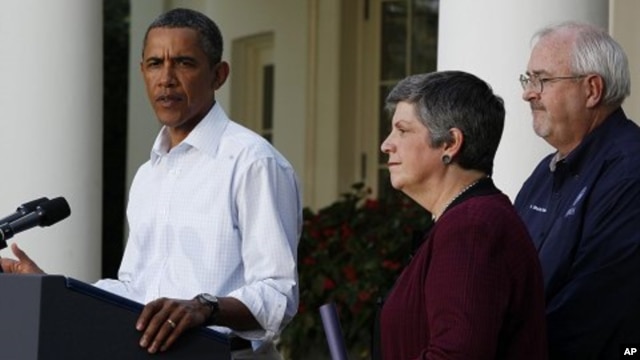 U.S. President Barack Obama speaks about damage done by Hurricane Irene next to Homeland Security Secretary Janet Napolitano (C) and Federal Emergency Management Agency Administrator Craig Fugate (R) in the Rose Garden of the White House, August 28, 2011