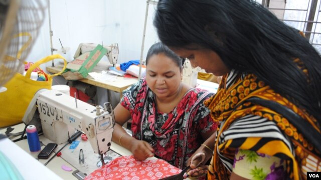 Women work in a tiny garment workshop opened and staffed by survivors of the collapse of Rana Plaza in Dhaka. (Amy Yee for VOA News)