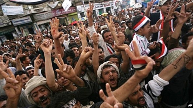 Yemeni anti-government protesters shout slogans during a demonstration demanding the resignation of President Ali Abdullah Saleh in Sana'a, April 28, 2011