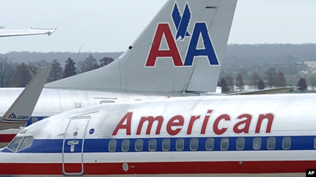 American Airlines planes sit at a gate at Washington's Ronald Reagan National Airport. American Airlines and its parent company are filing for bankruptcy protection as they try to cut costs and unload massive debt built up by years of high fuel prices and