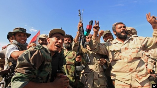 Anti-Gaddafi fighters celebrated the fall of Sirte October 20, 2011.